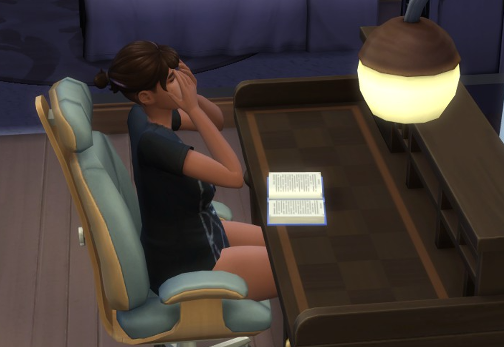 A Sims 4 screenshot, Ajei, a journal out in front of her, with her head in her hands frustrated.